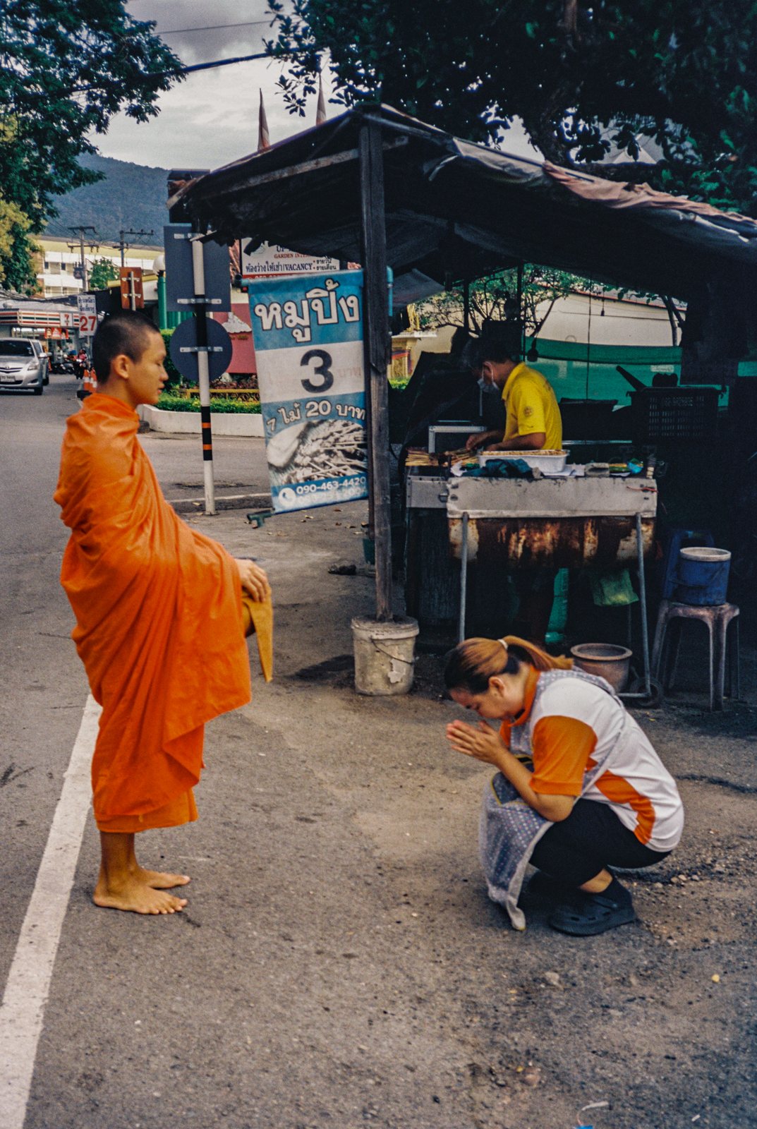 A monk receiving alms on a Chiang Mai street