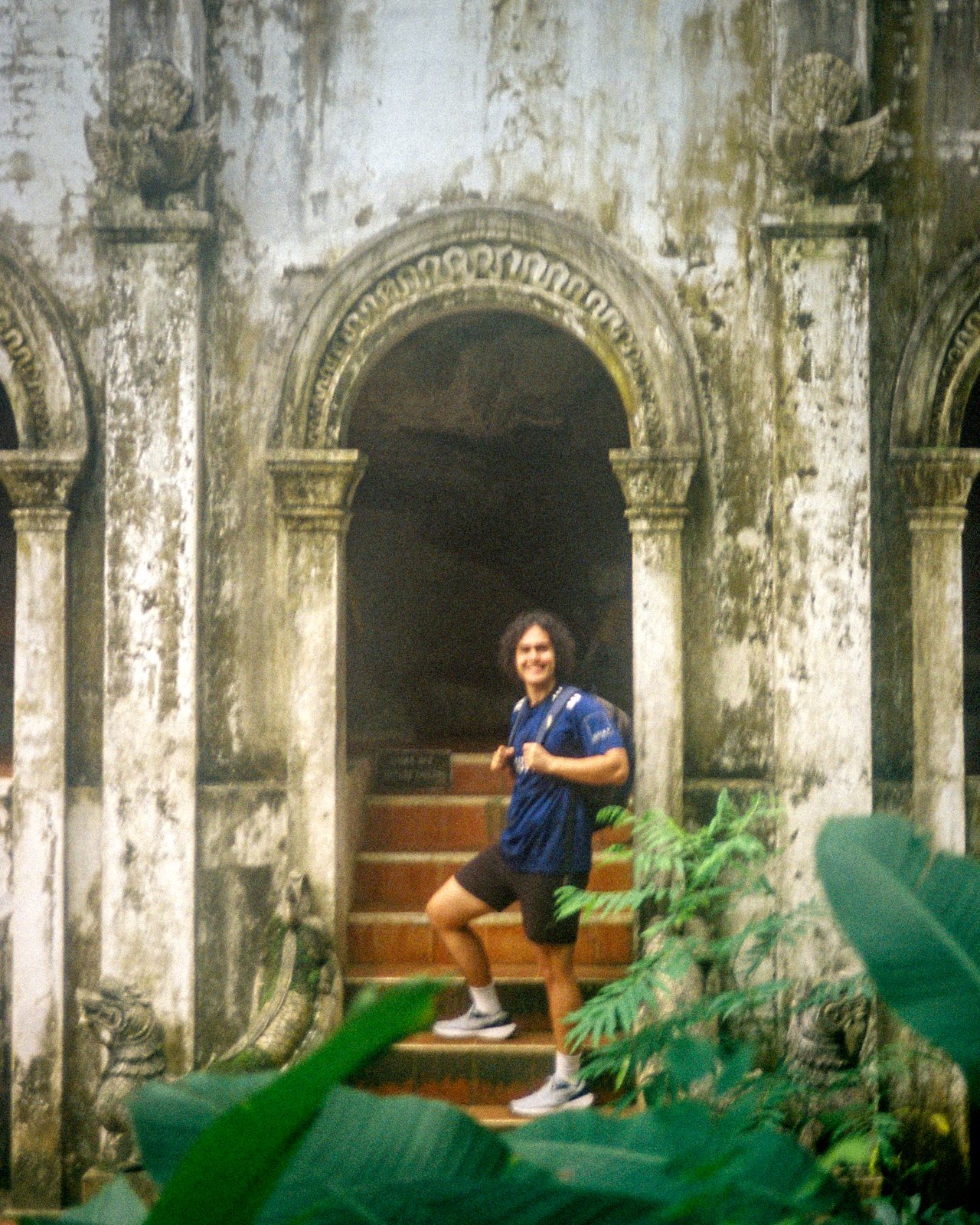On the red steps of an old temple doorway